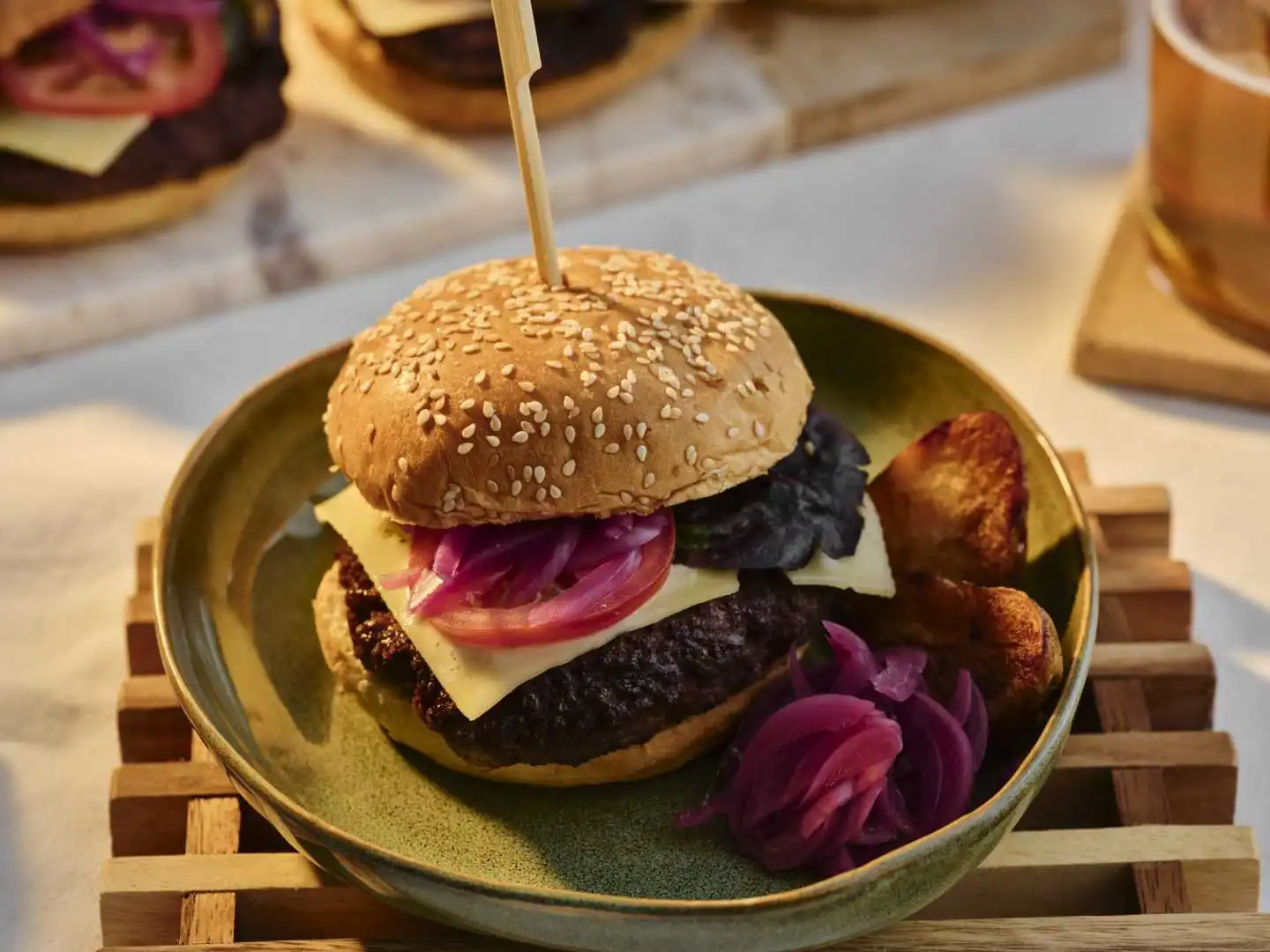 Charred beef smash burger with melted cheese and pickled red onions in a ceramic bowl served at a catered event in Bournemouth